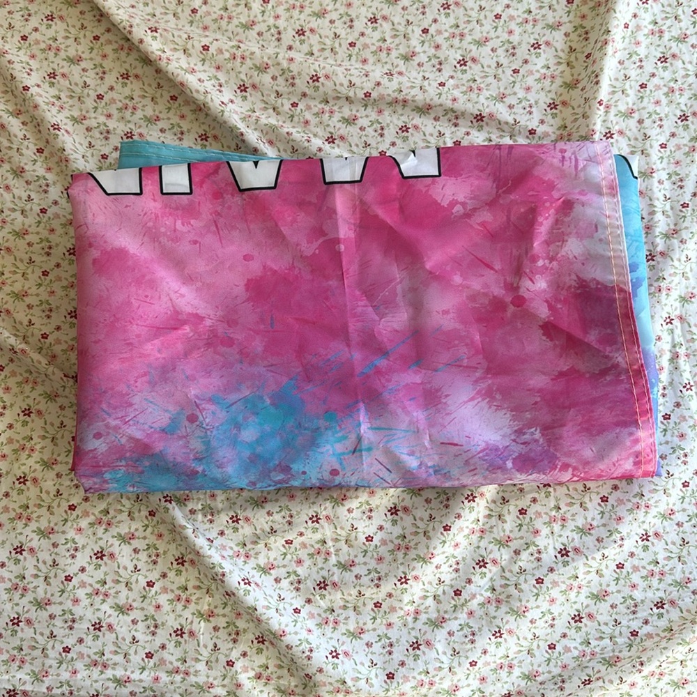 Multicolor flag says “main character vibes”